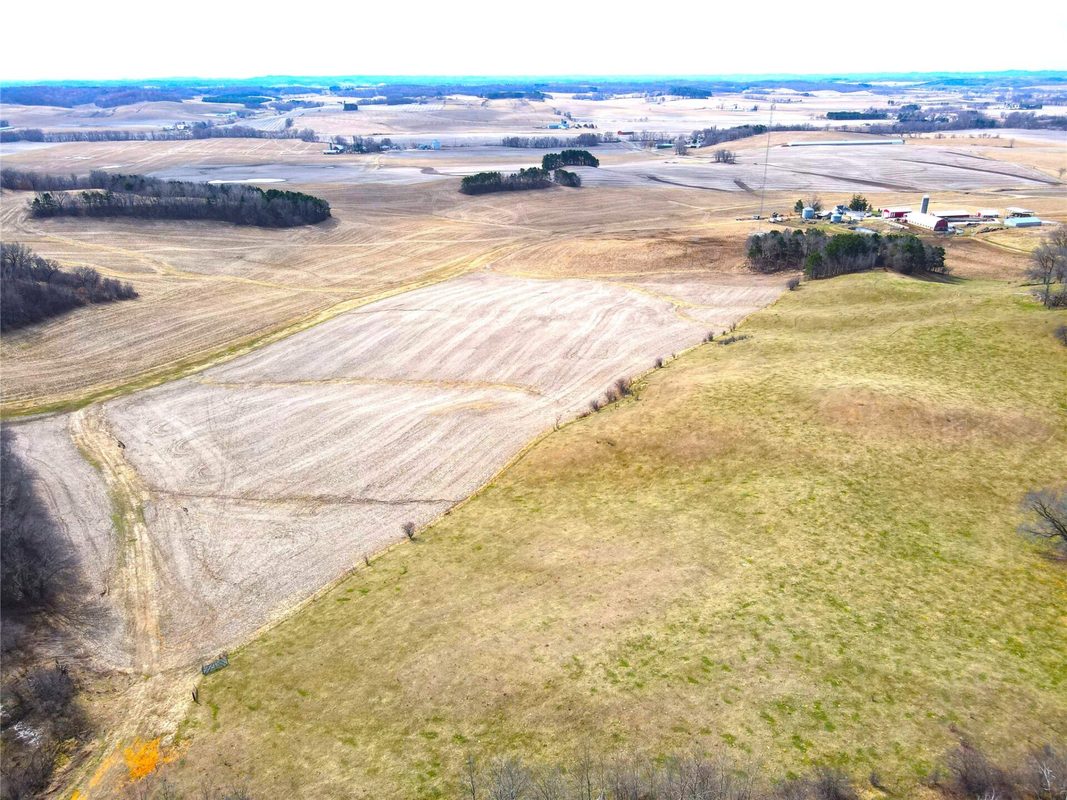 N41286 Halama Road, Independence WI 54747 - Aerial of rolling cropland with harvested field and pasture field side by side, farm at right - MLS #1599405 - image12