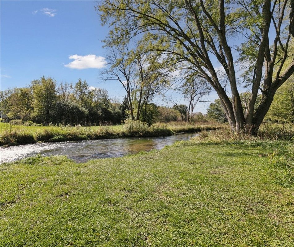 1171 30th Avenue, River Falls WI 54022 - Creek channel through wooded corridor with fall-color canopy and overhanging branches reflected in water - MLS #1599019 - image26