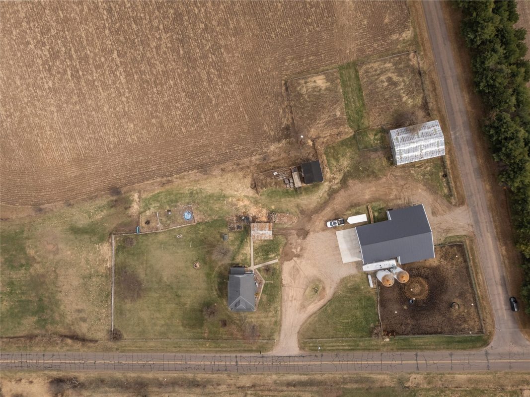 2003 23rd Street, Rice Lake WI 54868 - Straight-down aerial of farmstead showing barns, silos, house, and paddock from above - MLS #1598985 - image40