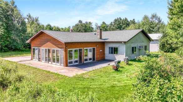 3828 W Walrath Road, Glen Flora WI 54563 - Log-sided ranch home with large four-season sunroom, attached garage, and concrete patio - MLS #1596271 - image1